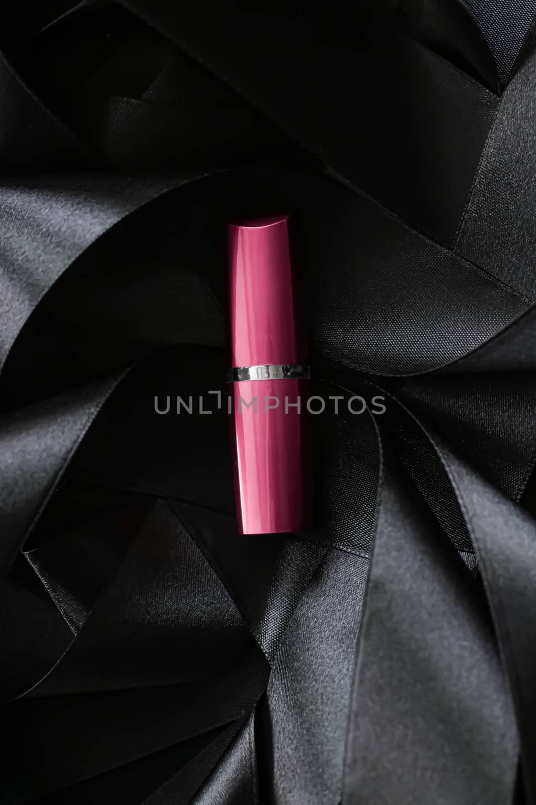 Pink lipstick on black silk background, luxury make-up and beauty cosmetics