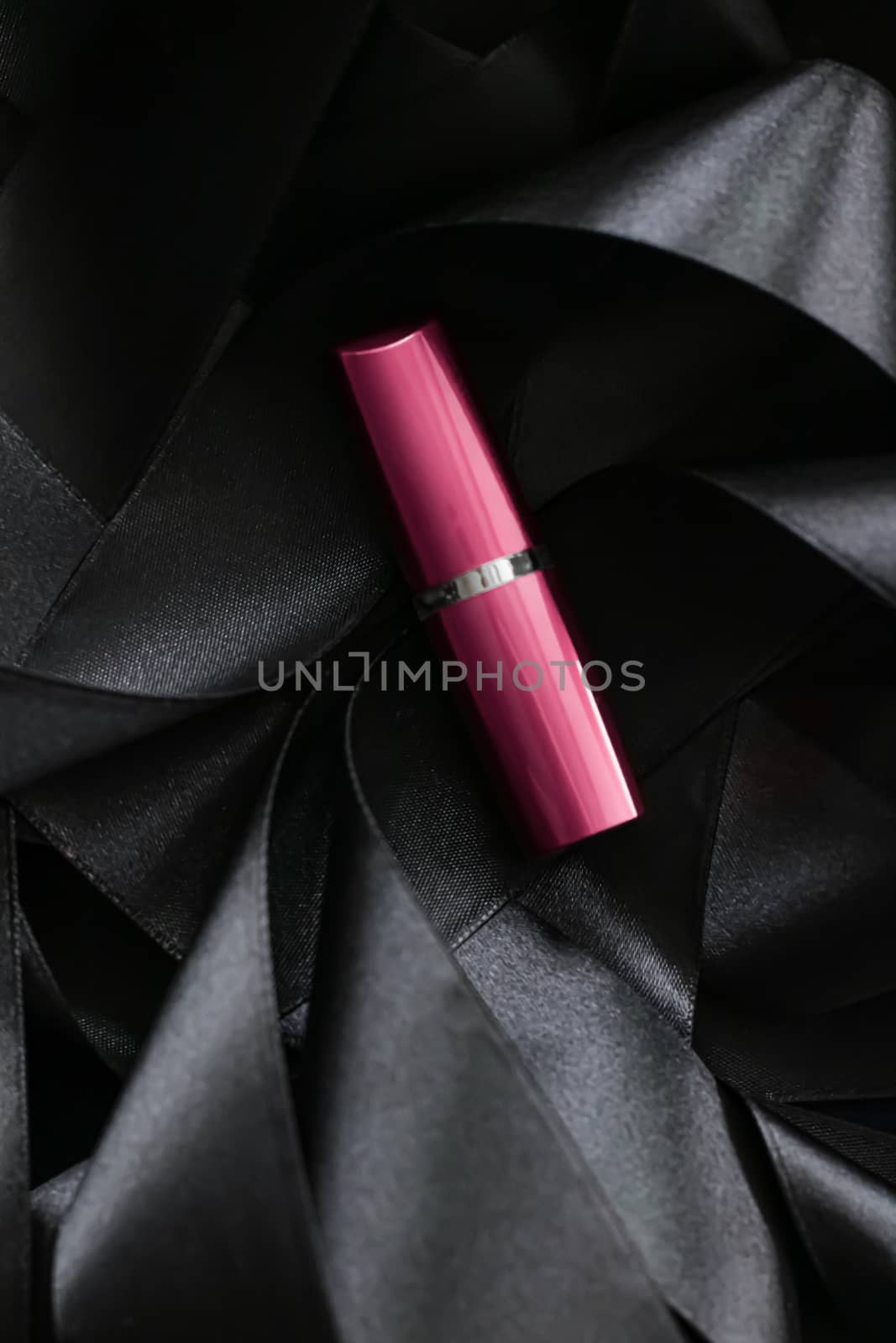 Pink lipstick on black silk background, luxury make-up and beaut by Anneleven