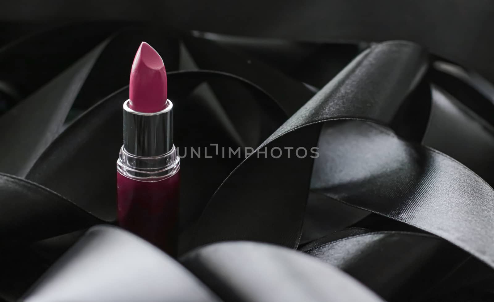 Pink lipstick on black silk background, luxury make-up and beaut by Anneleven