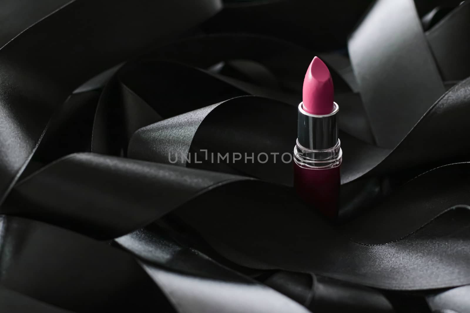 Pink lipstick on black silk background, luxury make-up and beaut by Anneleven