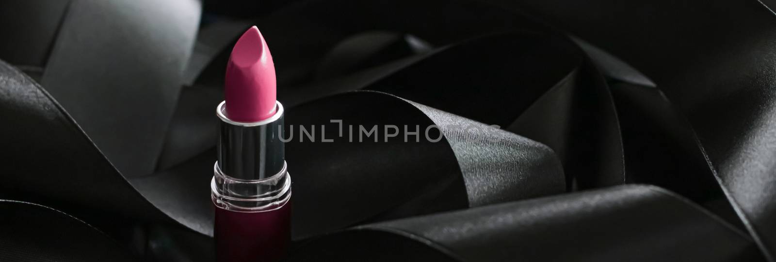 Pink lipstick on black silk background, luxury make-up and beauty cosmetics