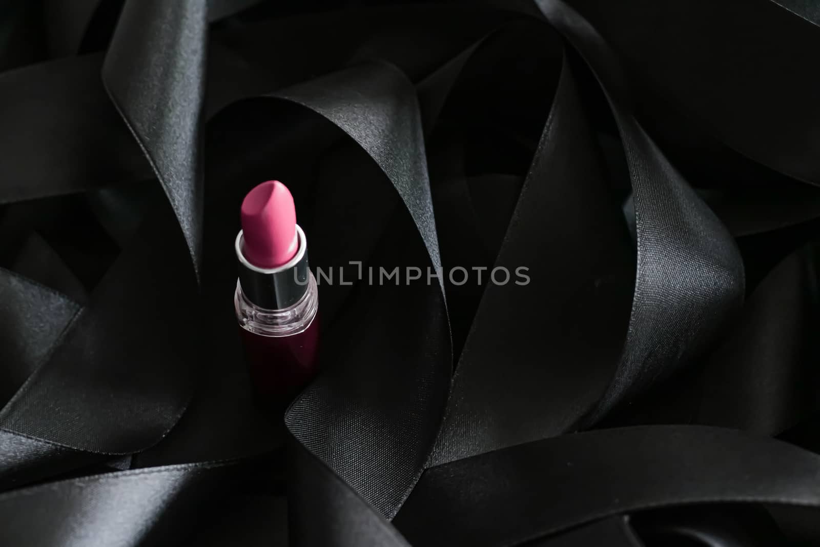 Pink lipstick on black silk background, luxury make-up and beaut by Anneleven