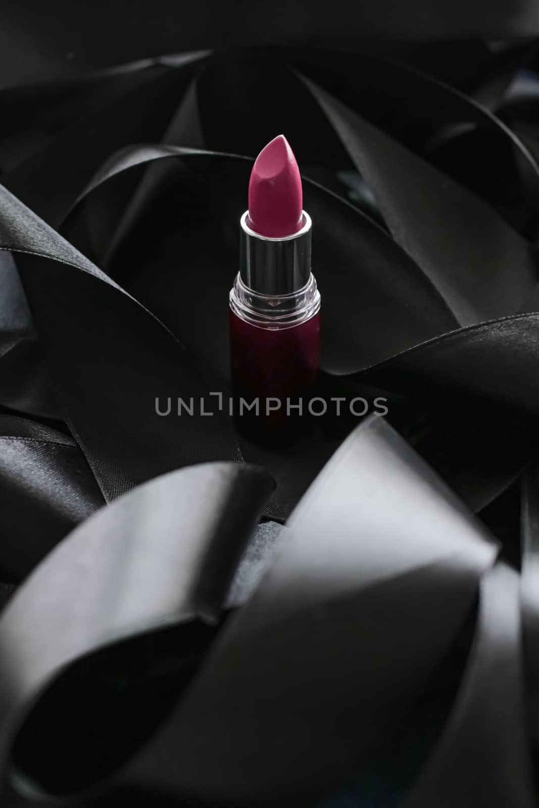 Pink lipstick on black silk background, luxury make-up and beaut by Anneleven