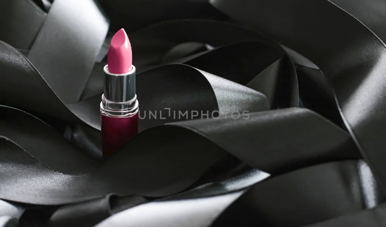 Pink lipstick on black silk background, luxury make-up and beaut by Anneleven