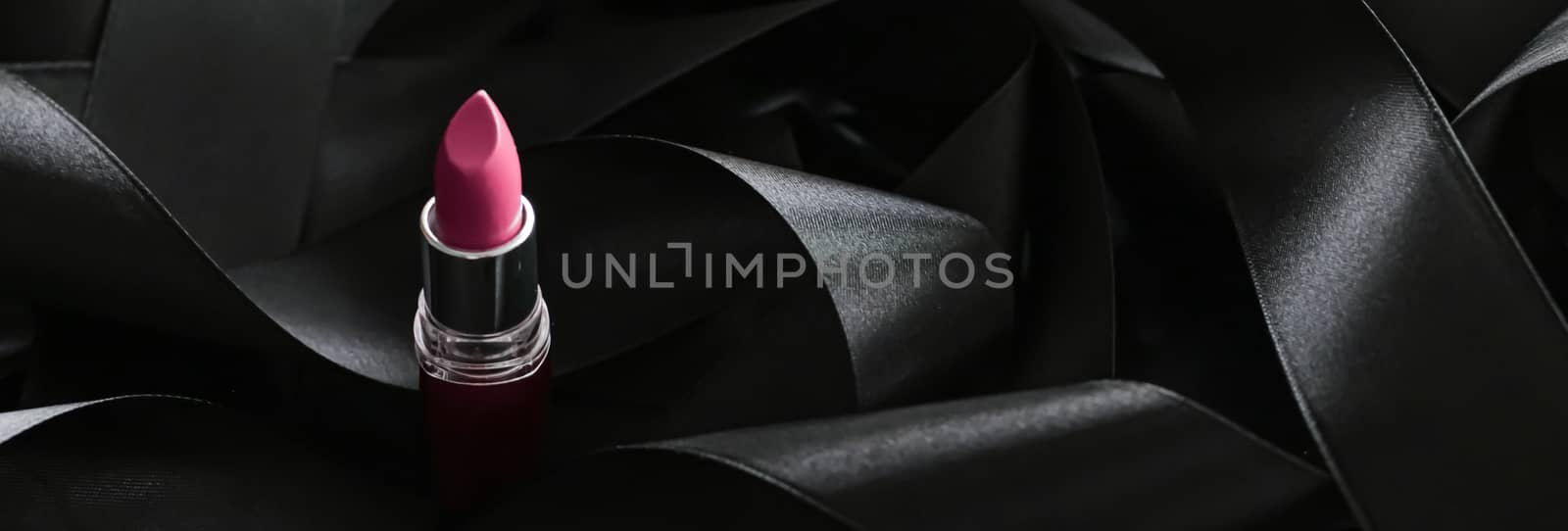 Pink lipstick on black silk background, luxury make-up and beauty cosmetics