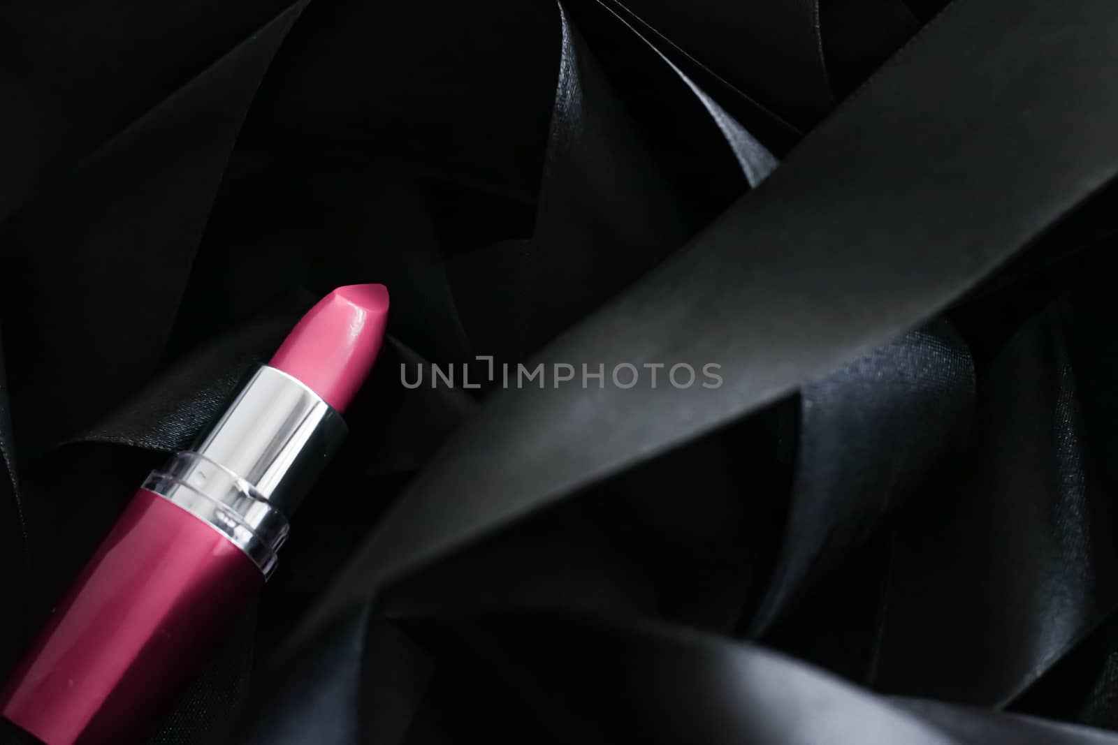 Pink lipstick on black silk background, luxury make-up and beaut by Anneleven