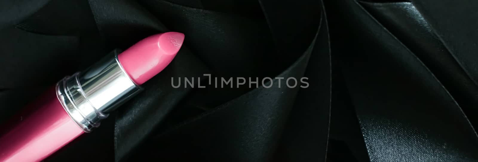 Pink lipstick on black silk background, luxury make-up and beauty cosmetics