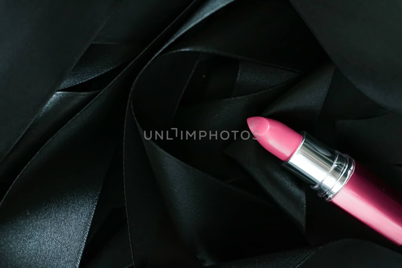 Pink lipstick on black silk background, luxury make-up and beaut by Anneleven