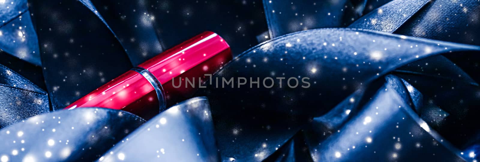 Red lipstick on blue silk and shiny glitter background, luxury make-up and beauty cosmetics