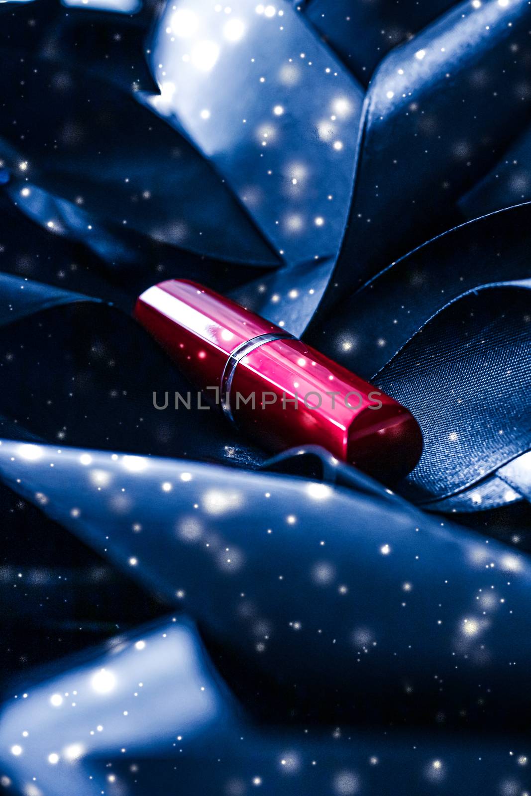 Red lipstick on blue silk and shiny glitter background, luxury make-up and beauty cosmetics