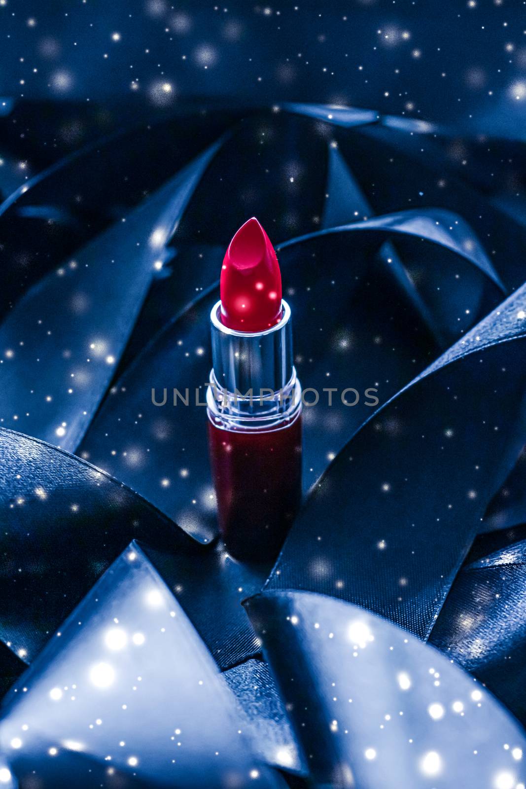 Red lipstick on blue silk and shiny glitter background, luxury make-up and beauty cosmetics