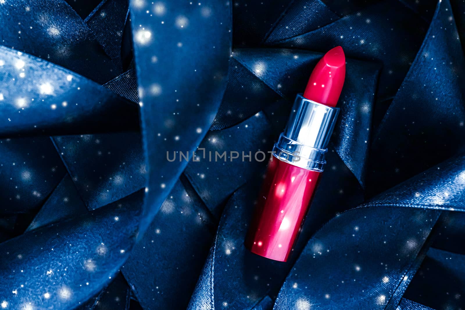 Red lipstick on blue silk and shiny glitter background, luxury m by Anneleven