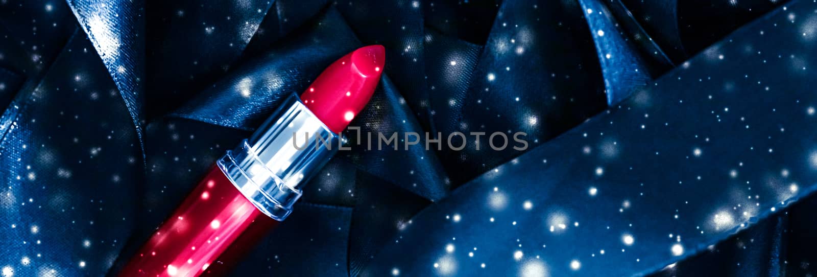 Red lipstick on blue silk and shiny glitter background, luxury make-up and beauty cosmetics