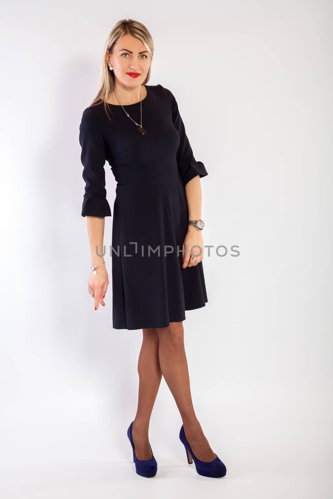 Young woman in a black dress is standing and posing by 25ehaag6