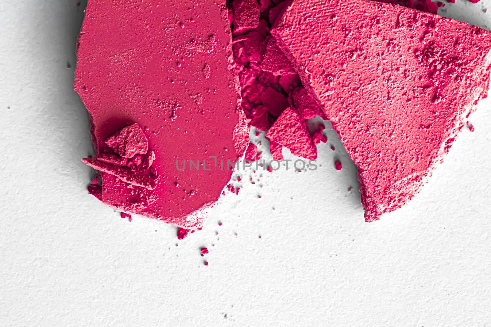 Pink eye shadow powder as makeup palette closeup isolated on white background, crushed cosmetics and beauty textures