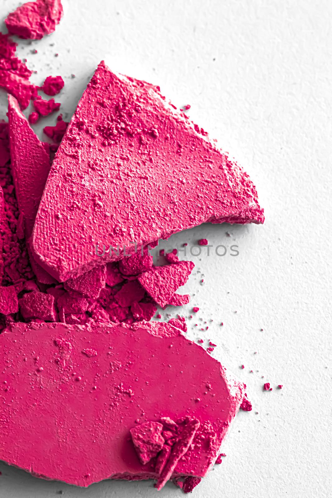 Pink eye shadow powder as makeup palette closeup isolated on white background, crushed cosmetics and beauty textures