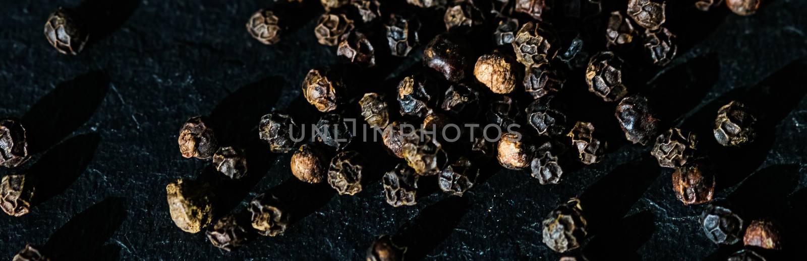 Black pepper closeup on luxury stone background as flat lay, dry by Anneleven