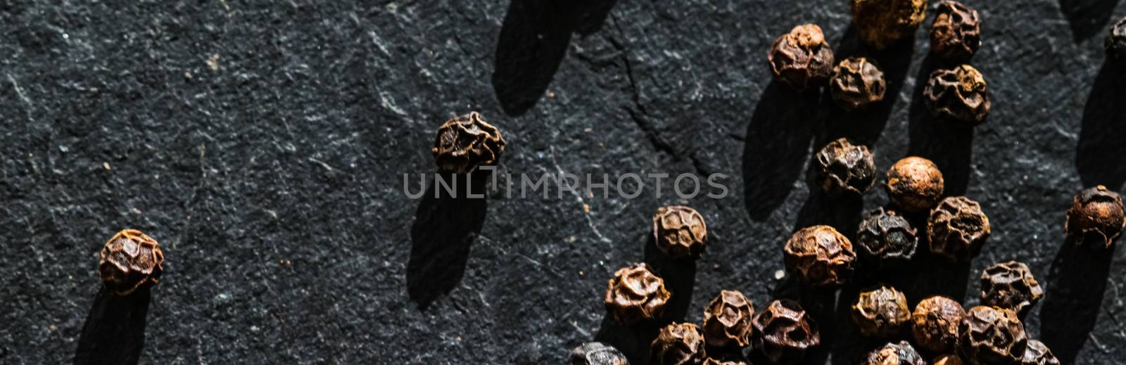 Black pepper closeup on luxury stone background as flat lay, dry by Anneleven