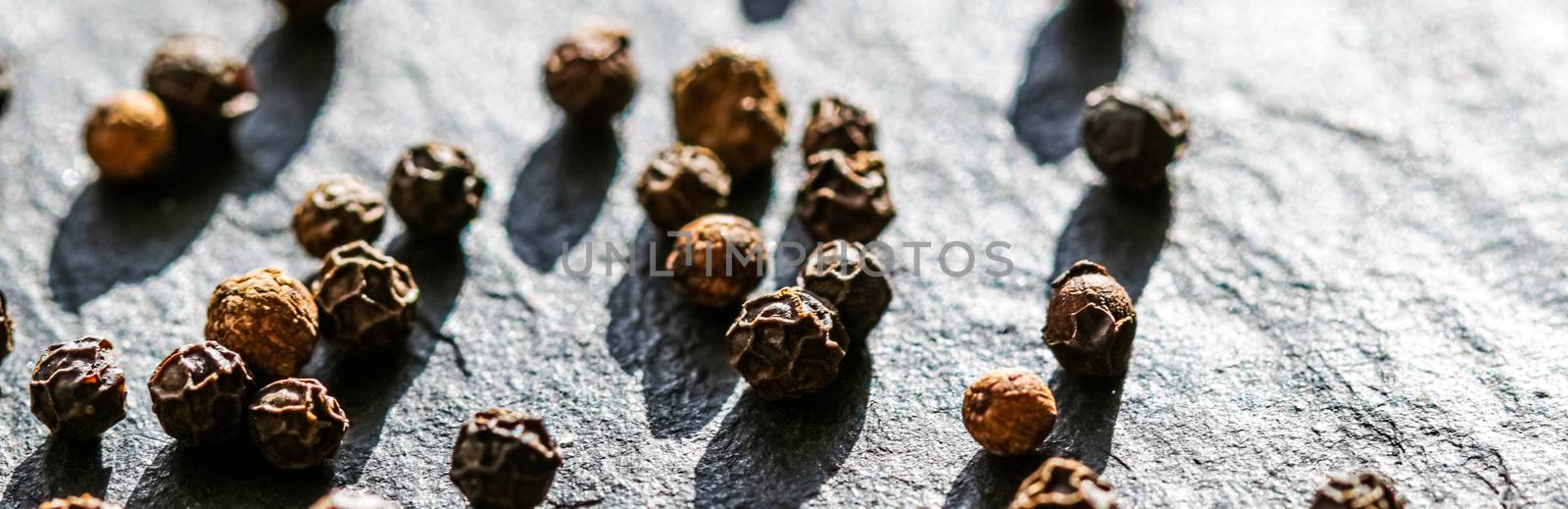 Black pepper closeup on luxury stone background as flat lay, dry by Anneleven