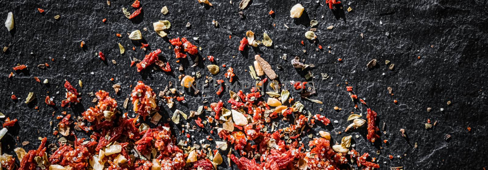 Dried tomato and chili pepper closeup on luxury stone background by Anneleven