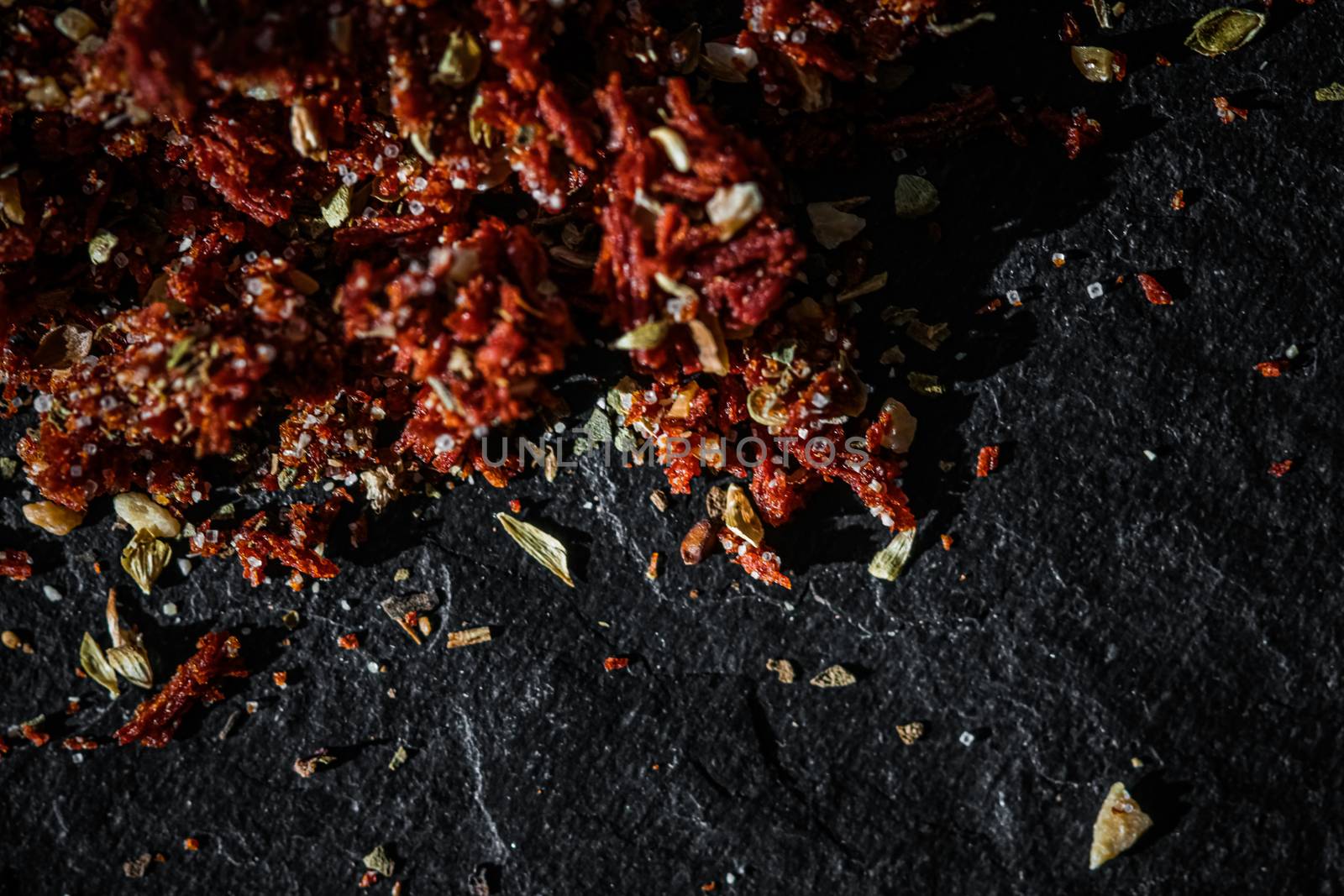 Dried tomato and chili pepper closeup on luxury stone background as flat lay, dry food spices and recipe ingredients