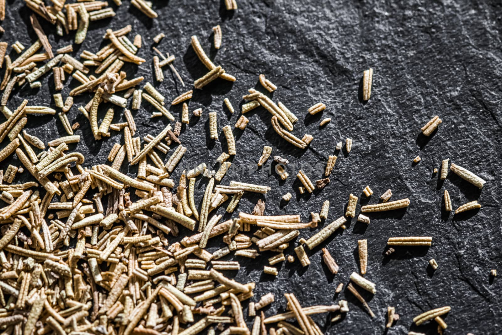 Rosemary closeup on luxury stone background as flat lay, dry food spices and recipe ingredients