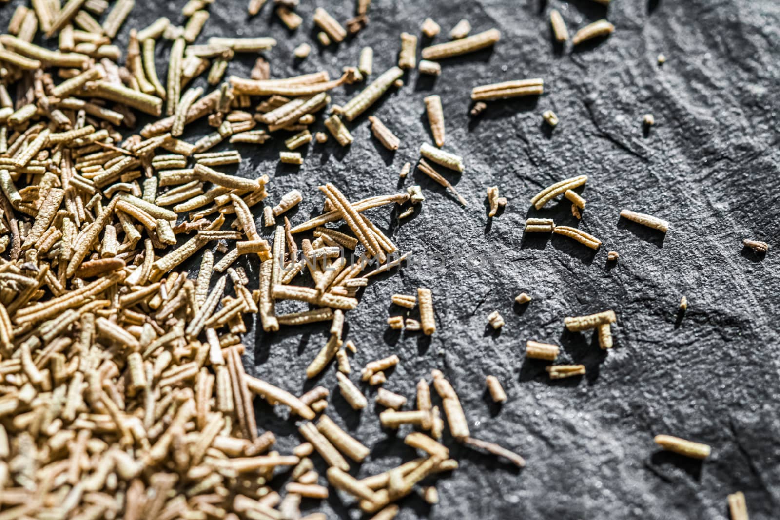 Rosemary closeup on luxury stone background as flat lay, dry food spices and recipe ingredients