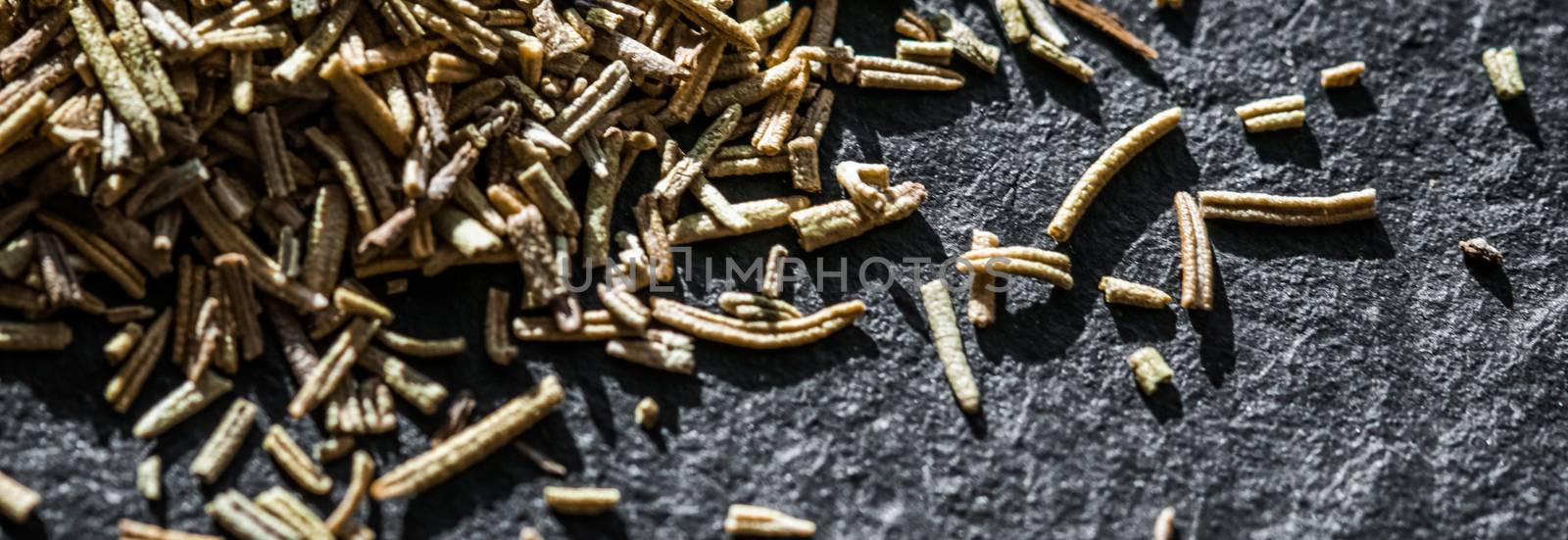 Rosemary closeup on luxury stone background as flat lay, dry food spices and recipe ingredients