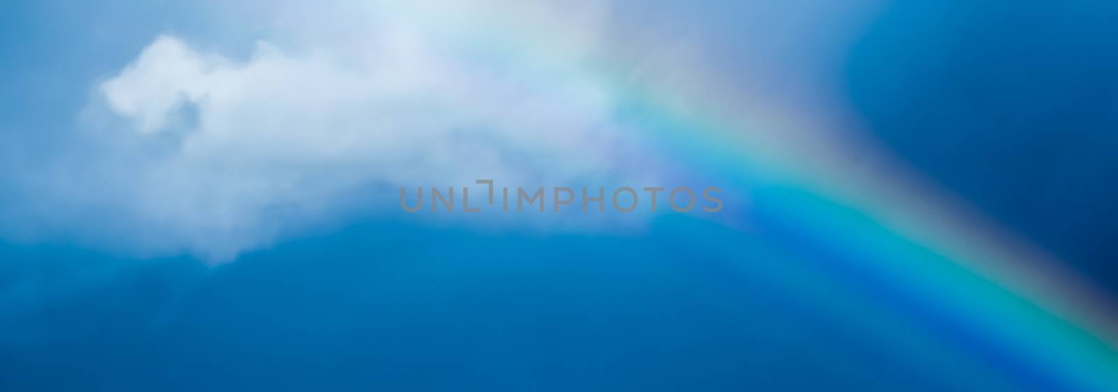 Rainbow in a dreamy blue sky, spiritual and nature backgrounds