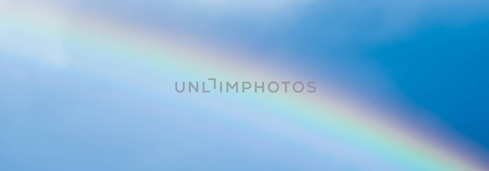 Rainbow in a dreamy blue sky, spiritual and nature backgrounds