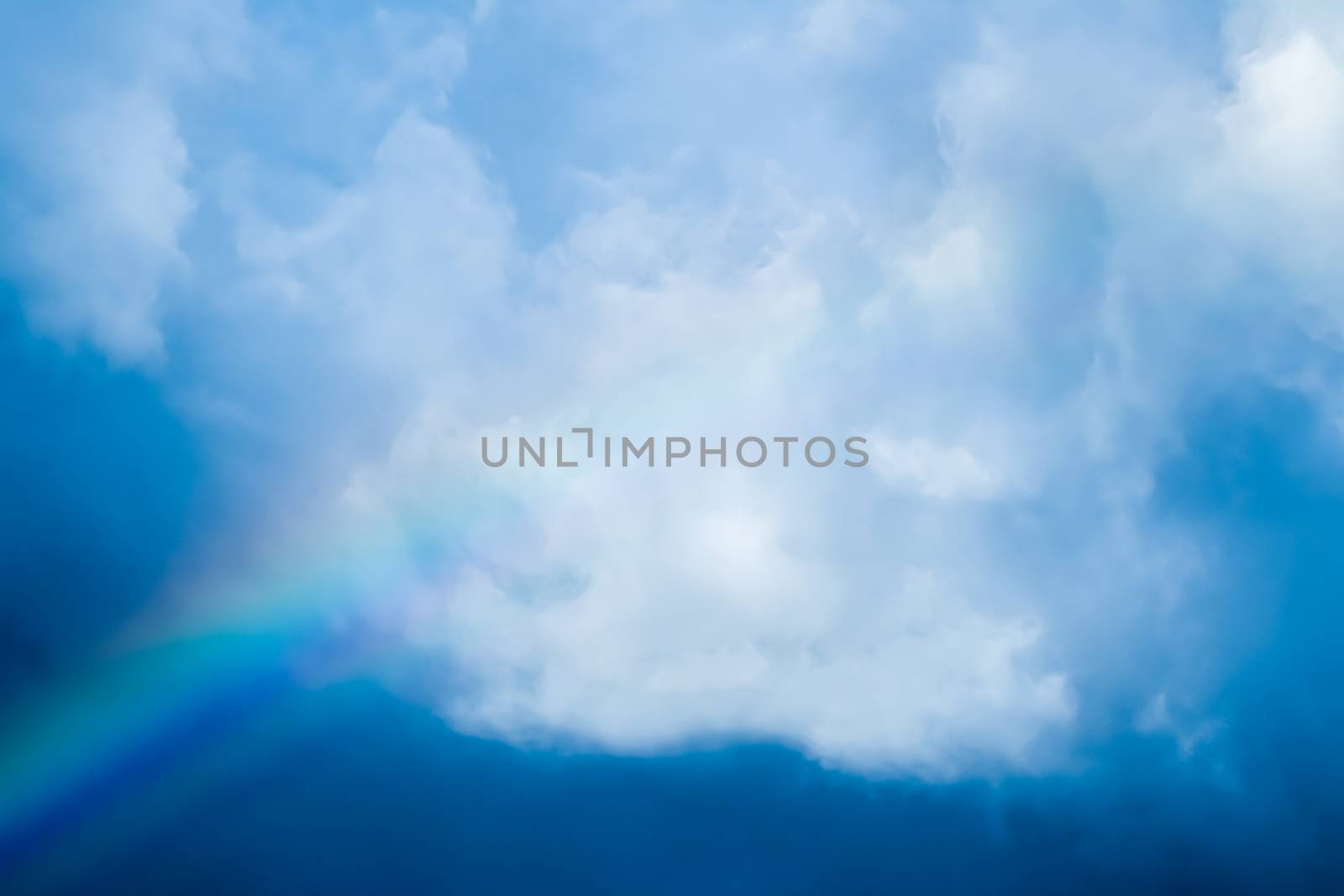 Rainbow in a dreamy blue sky, spiritual and nature backgrounds