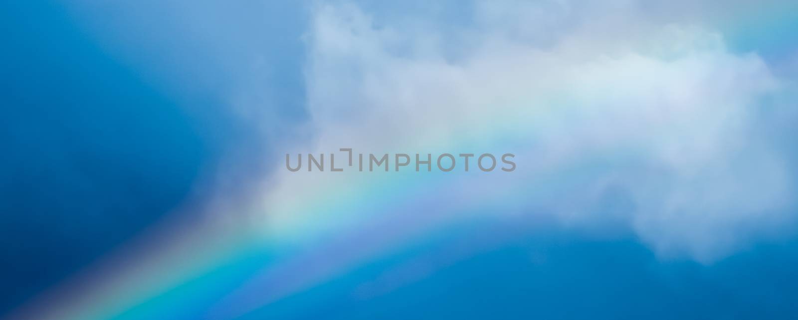 Rainbow in a dreamy blue sky, spiritual and nature backgrounds