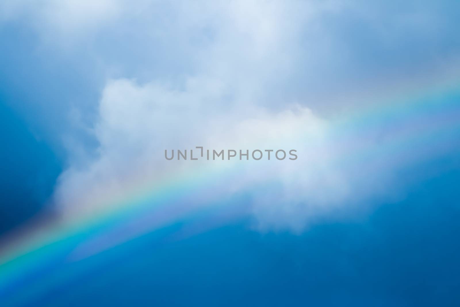 Rainbow in a dreamy blue sky, spiritual and nature backgrounds