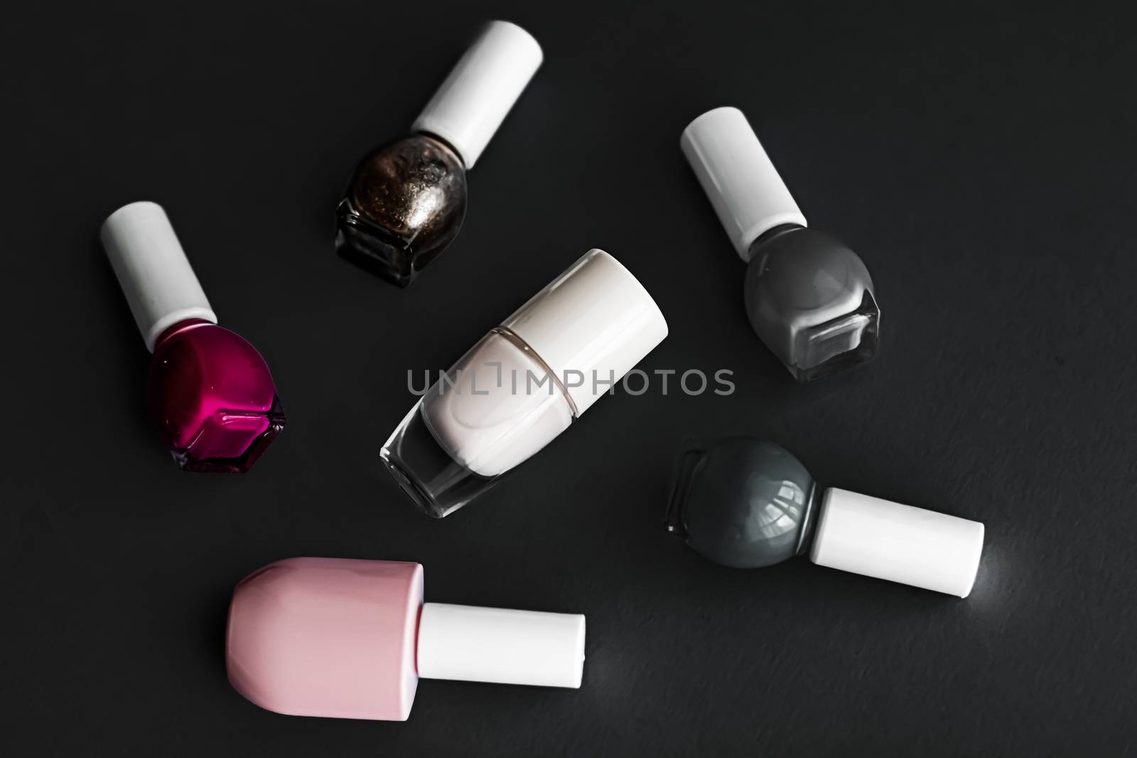 Nail polish bottles on black background, beauty brand by Anneleven