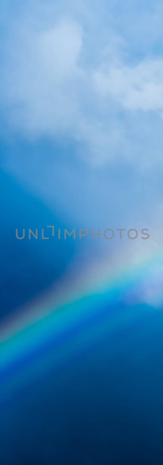 Rainbow in a dreamy blue sky, spiritual and nature backgrounds