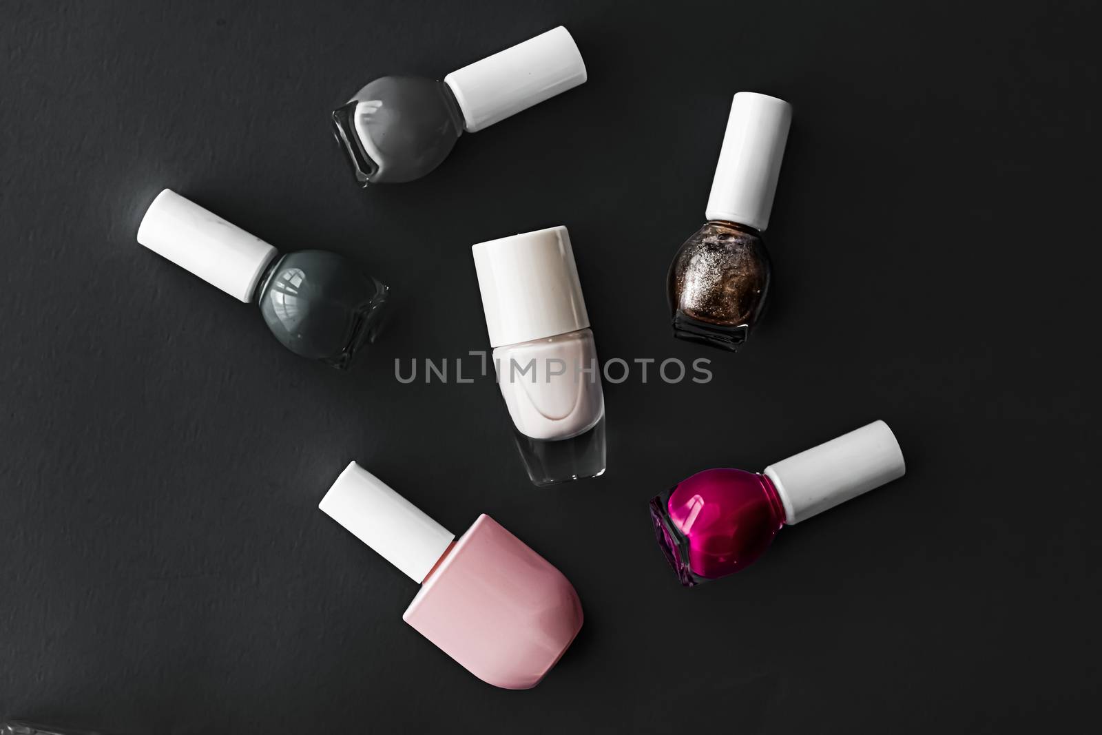 Nail polish bottles on black background, beauty brand by Anneleven
