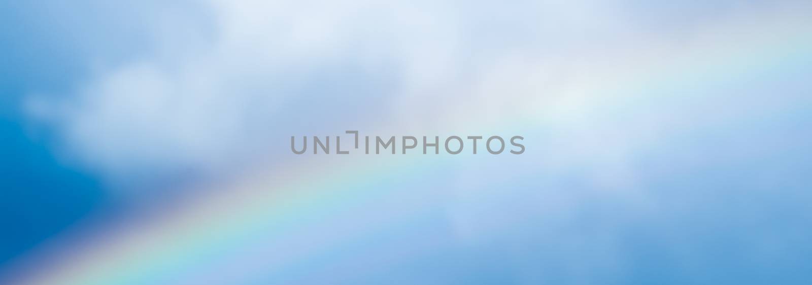 Rainbow in a dreamy blue sky, spiritual and nature backgrounds