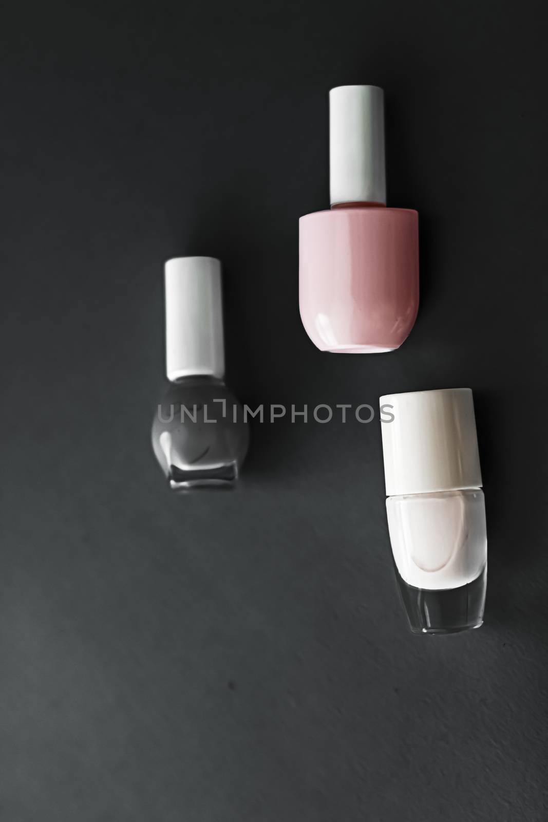 Nail polish bottles on black background, beauty brand by Anneleven