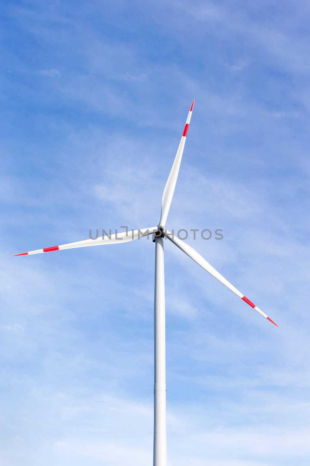A windmill with a blue sky in the background by 25ehaag6