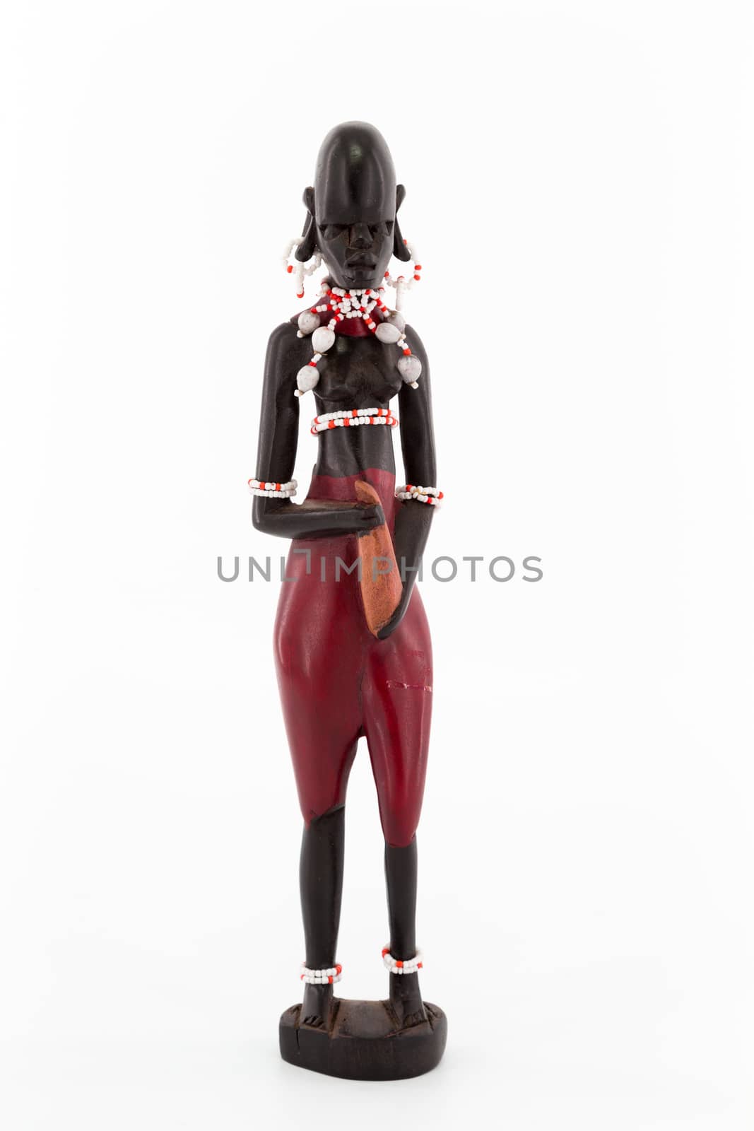A wooden figure of a Maasai women on white background