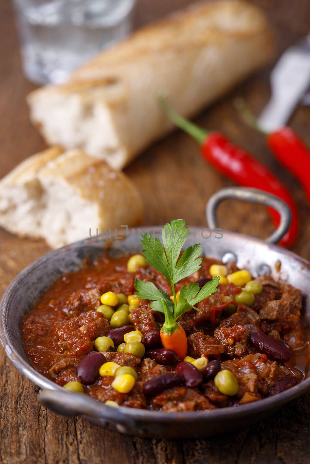 tasty chili con carne on wood