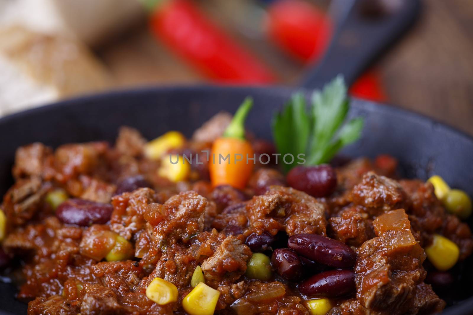 tasty chili con carne on wood