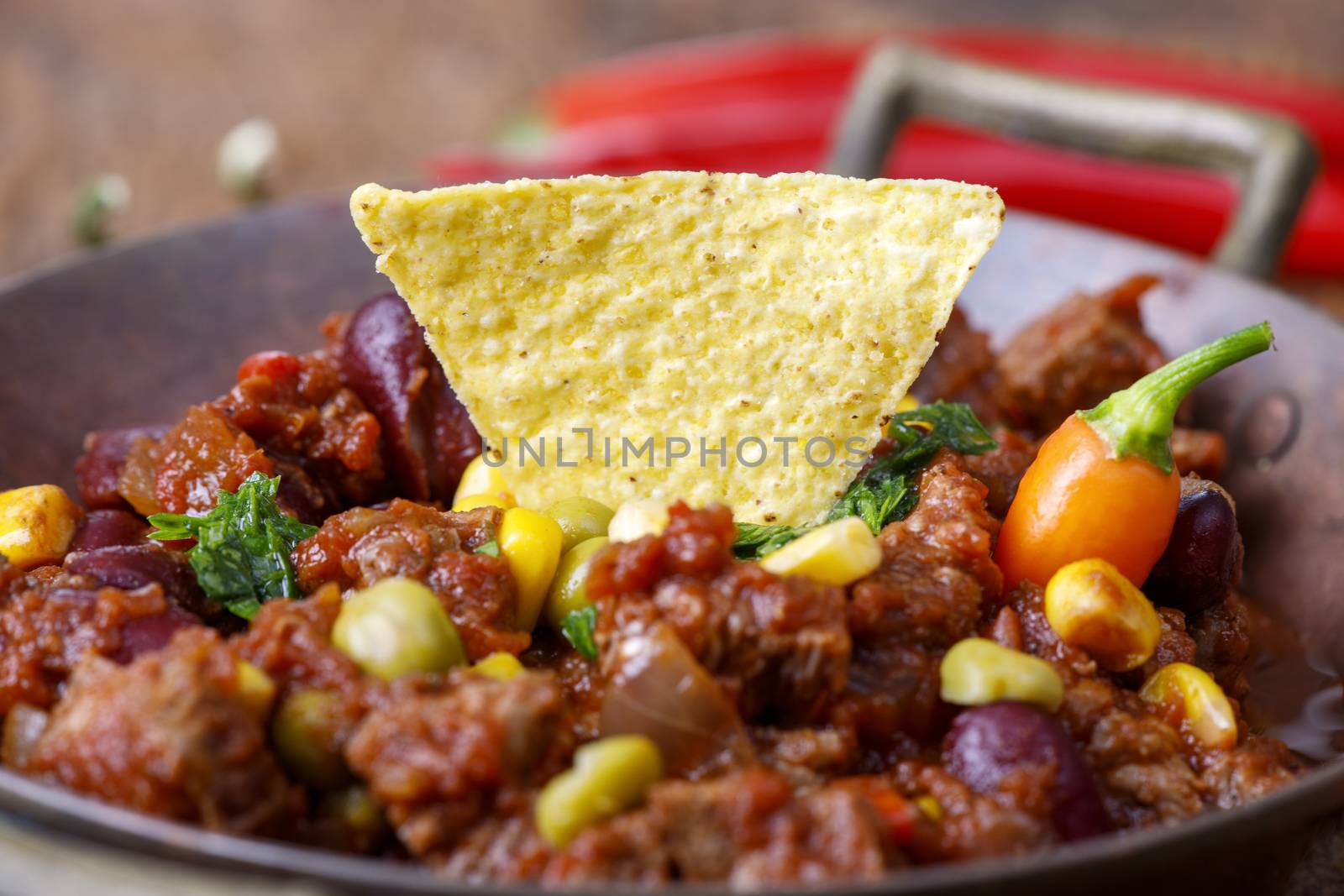 tasty chili con carne on wood