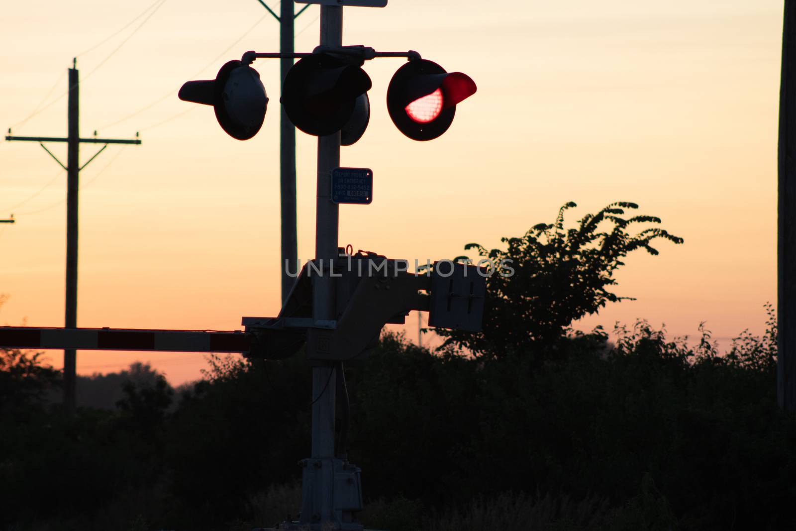 Rail Road crossing and tracks at sunset . High quality photo