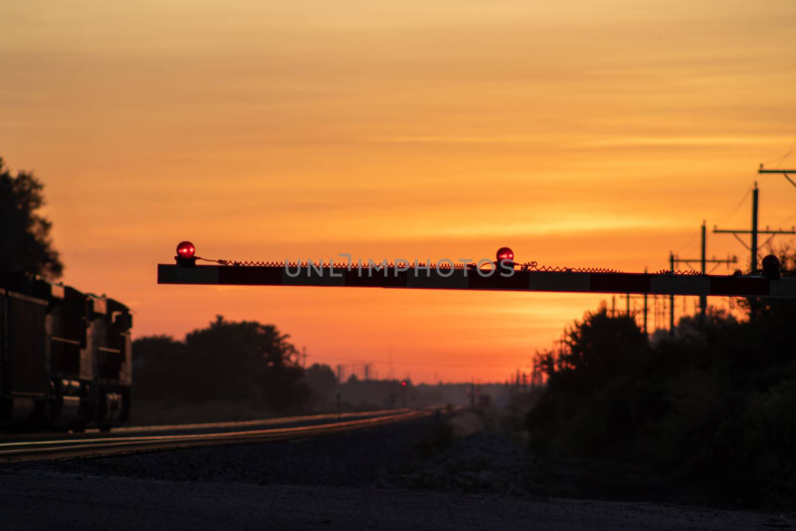 Rail Road crossing and tracks at sunset . High quality photo