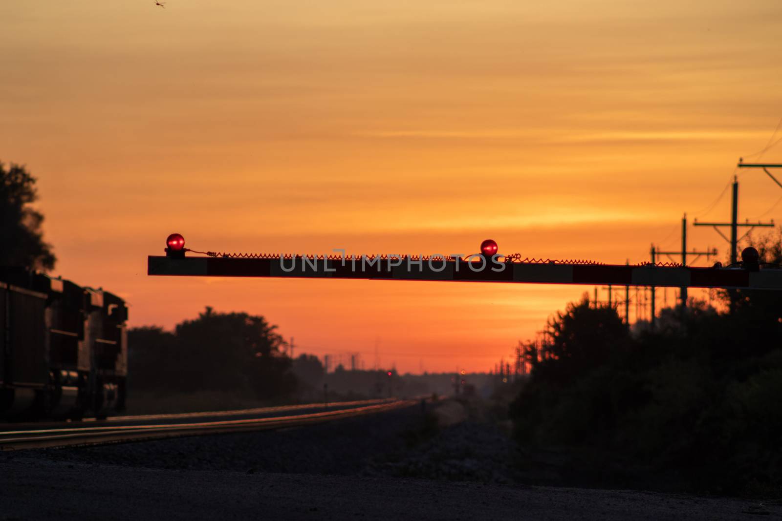 Rail Road crossing and tracks at sunset . High quality photo