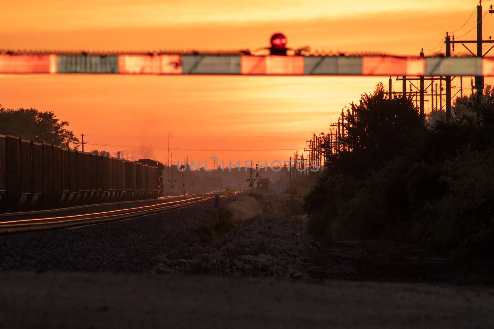 Rail Road crossing and tracks at sunset by gena_wells