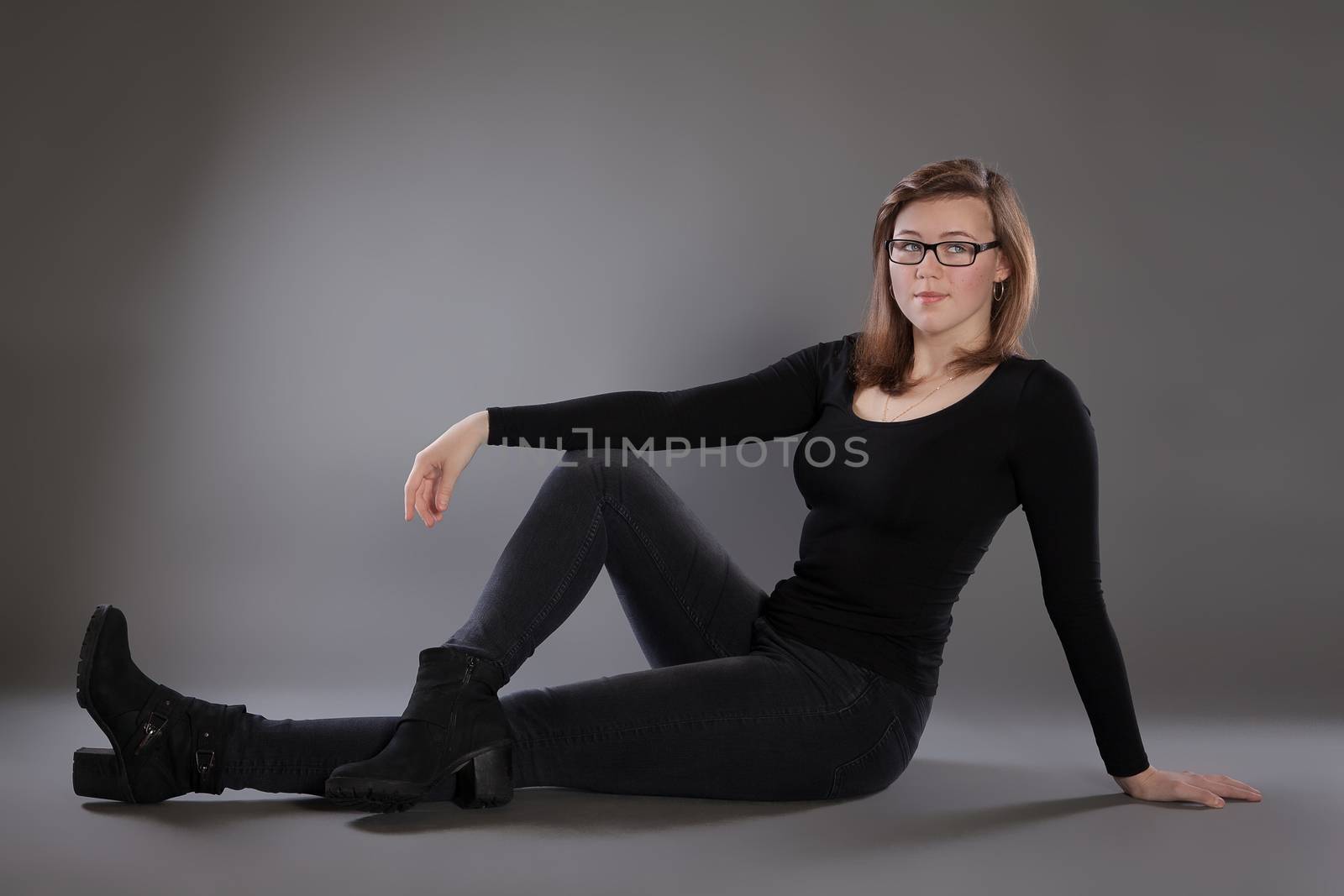 Young woman is sitting on the floor