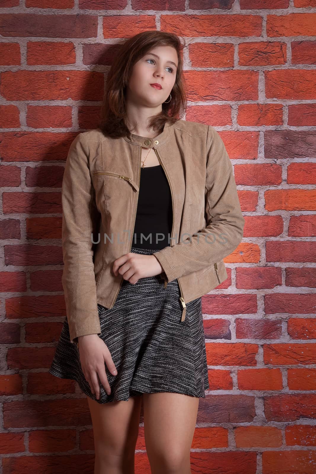 Young woman is standing on the wall
