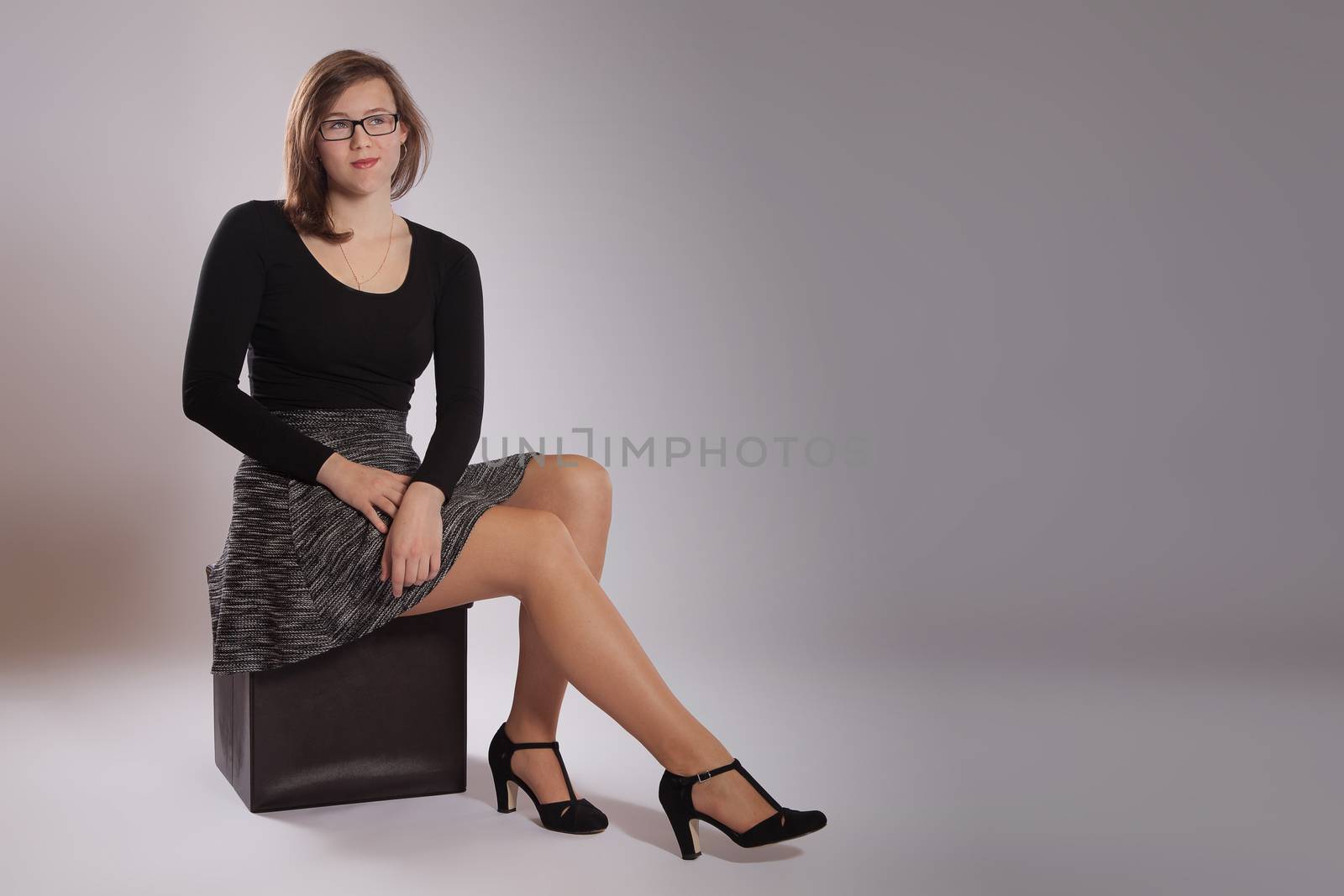 Young woman is sitting on a stool by 25ehaag6